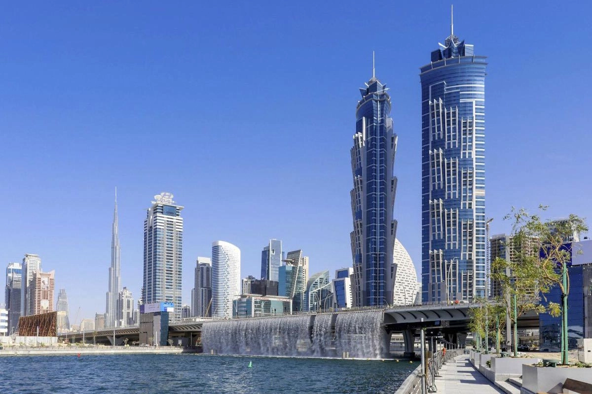Aerial panoramic view of Dubai's Business Bay skyline at sunset, showcasing luxury high-rise residential towers and commercial skyscrapers along the Dubai Water Canal, highlighting why it is Dubai’s Hottest Property destination.