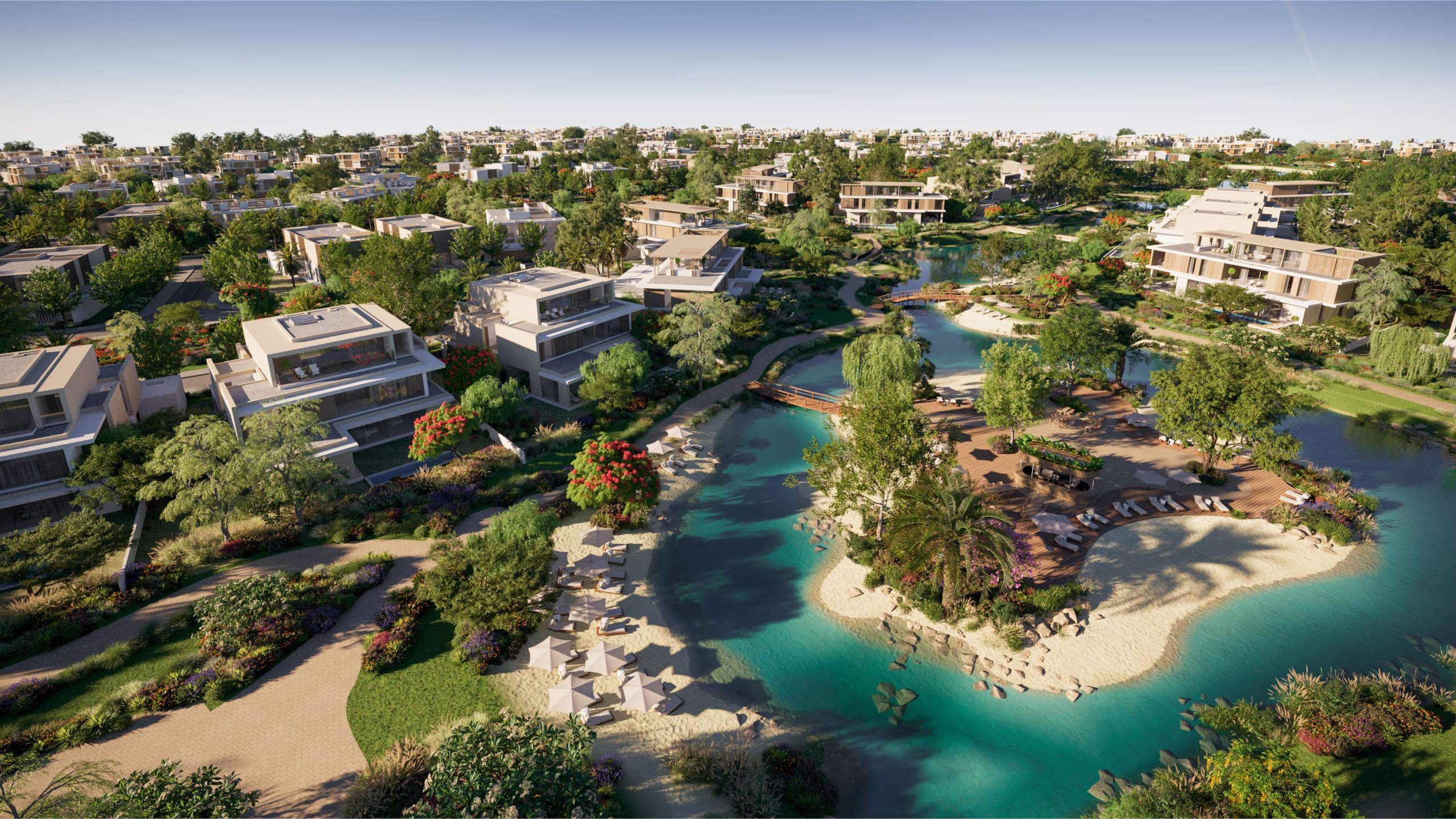 Aerial view of the top villa communities for families in Dubai showcasing modern family homes, swimming pools, and landscaped parks.