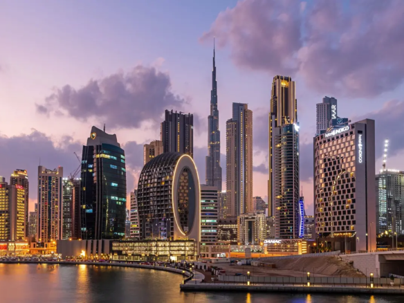 Aerial view of Dubai’s skyline featuring iconic luxury towers and residential districts, highlighting the top areas for high-yield rental income in Dubai.